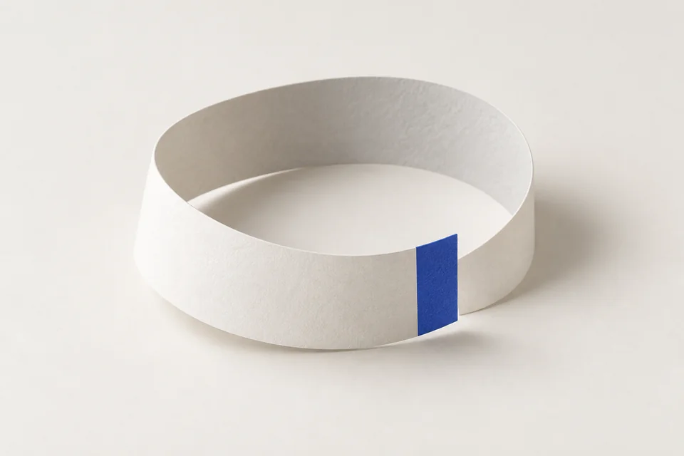 A paper ribbon curves back toward its starting point.